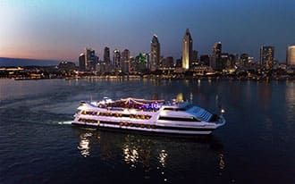 The Inspiration Hornblower cruising San Diego Harbor in the evening.