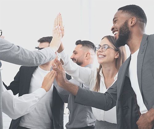 diverse group of smiling people giving high 5